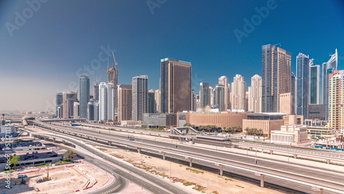 Dubai Marina skyscrapers and Sheikh Zayed road with metro railway aerial timelapse, United Arab Emirates