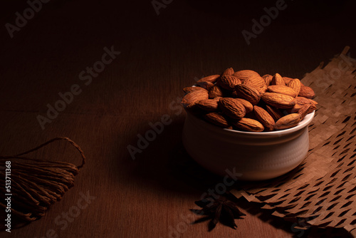 close up some almonds in bowl in dark background photo