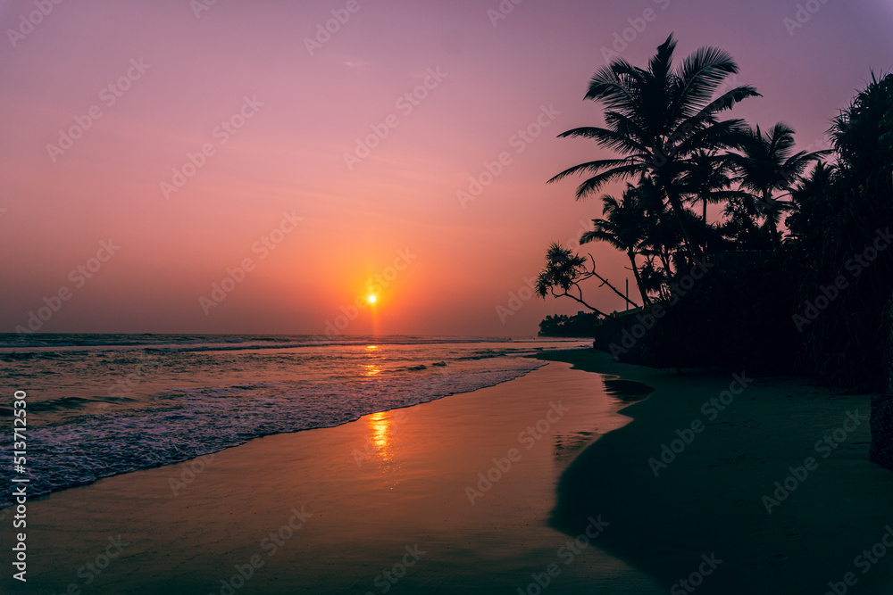 Male model walking on tropical beach at sunset, beautiful holiday landscape.