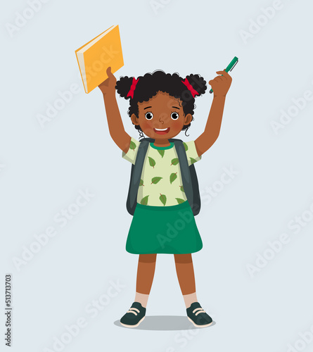 Happy little African girl student with backpack holding book and pen feeling excited to be back to school