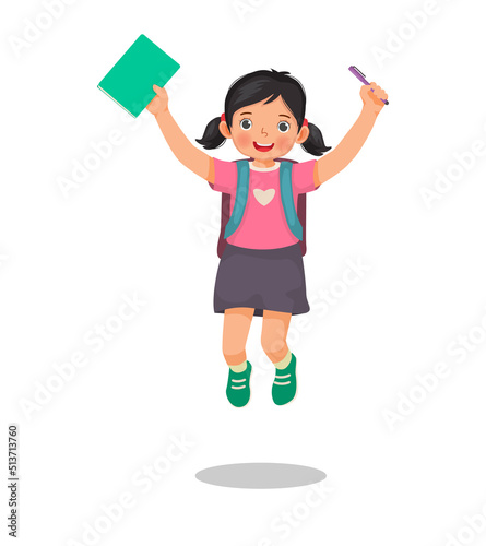 Happy little girl student with backpack holding book and pen jumping feeling excited to be back to school