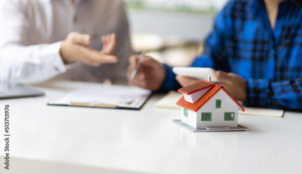 Real estate agents are discussing legal signing of home purchases, renting and mortgage agreements. Real estate agents are discussing legal signing of home purchases, renting and mortgage agreements.
