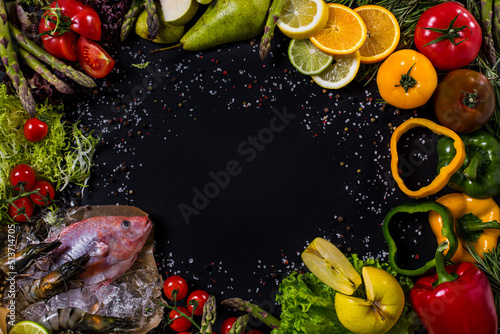 Fototapeta Naklejka Na Ścianę i Meble -  Black background with seafood, vegetables and fruits