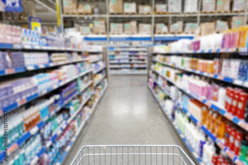Blurred supermarket aisle with colorful shelves of merchandise