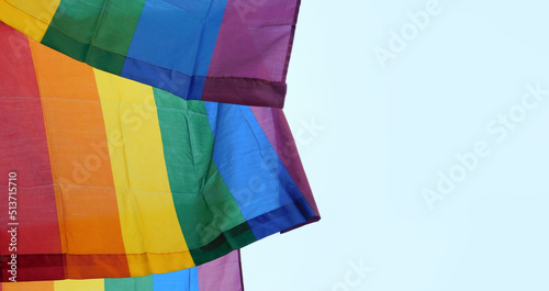 The rainbow flag, gay pride or LGBTQ symbol on light sky background