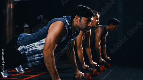 Sporty group of people doing push-ups on weights workout exercise in the fitness gym healthy lifestyle bodybuilding, Athlete builder muscles lifestyle.