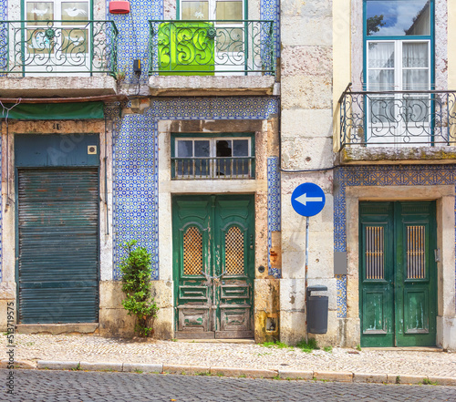 Fragment of the facade of the house with decorative elements and azulejo tiles. Lisbon, Portugal