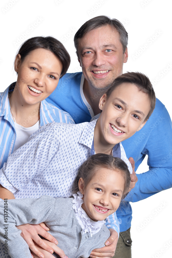 Happy smiling family of four posing on white background Happy smiling family of four posing on white background
