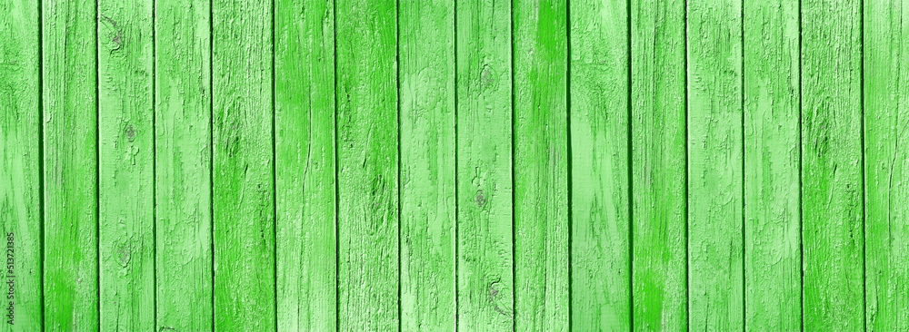 Old wooden boards with weathered bright green grass color paint wide texture. Shabby wood plank rustic vintage background Old wooden boards with weathered bright green grass color paint wide texture. Shabby wood plank rustic vintage background