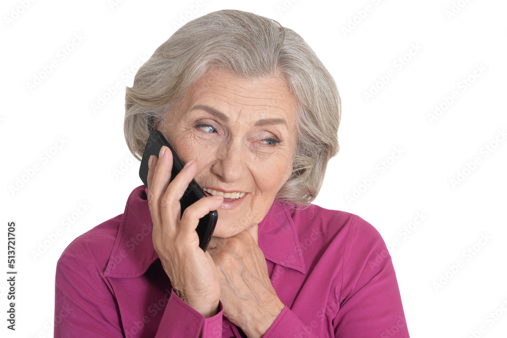 Beautiful senior woman talking on smartphone against white background Beautiful senior woman talking on smartphone against white background