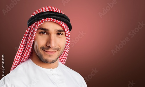 Man in Arab qatari dress on gradien background photo