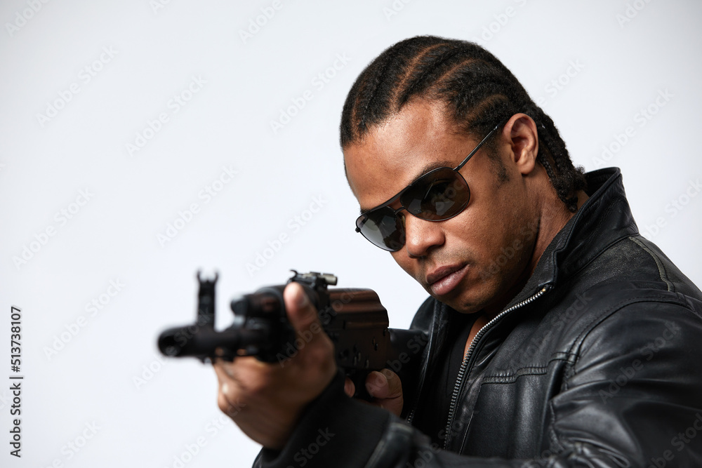 A black African American police detective man on the job with a gun A black African American police detective man on the job with a gun