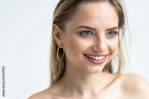 Portrait of emotive good-looking caucasian woman laughing while looking aside and standing against white background.