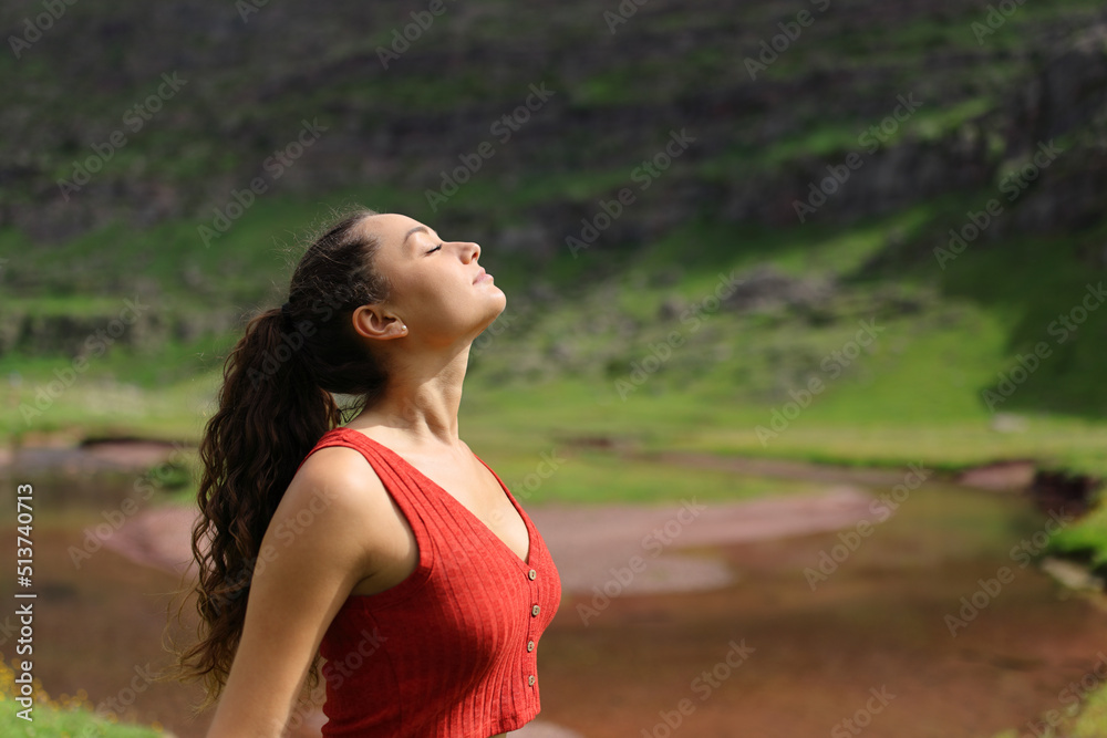 Woman breathing fresh air in a riverside Woman breathing fresh air in a riverside