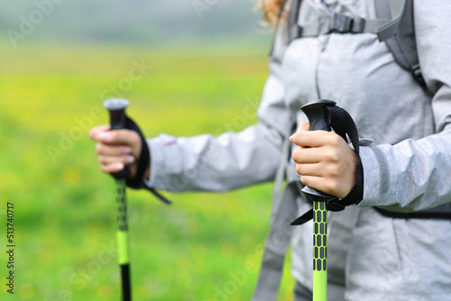 Hiker hands using poles to walk in the mountain