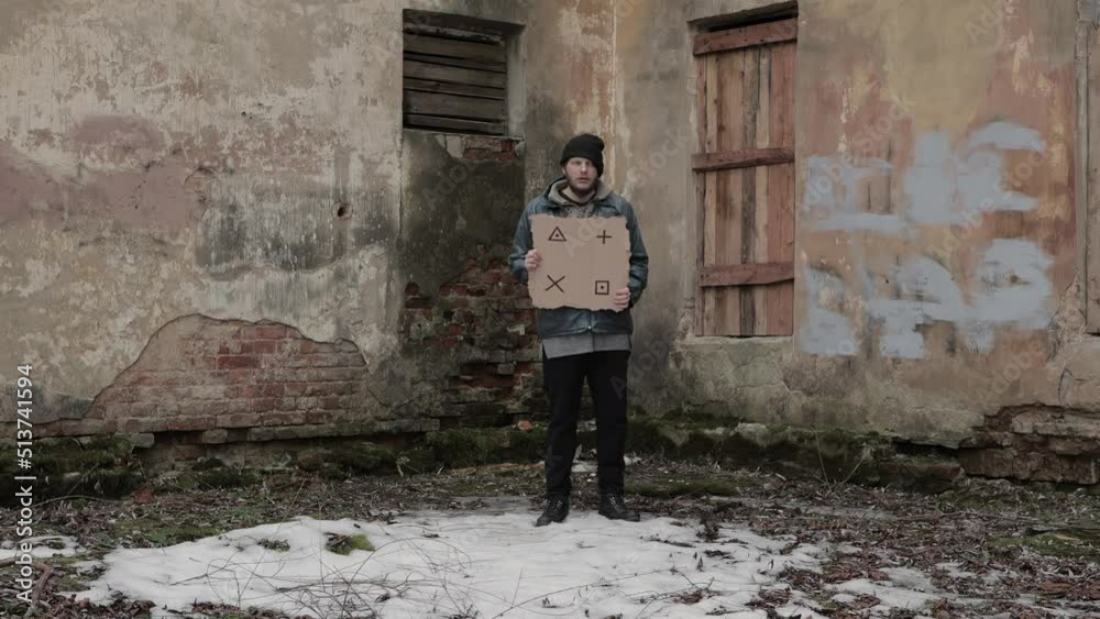 Homeless holds piece of cardboard with markers for planar tracking. Refugee looking for job. Male tramp in dirty clothes. Below poverty line. Bearded fugitive beggar. Immigrant. Drunkenness Homeless holds piece of cardboard with markers for planar tracking. Refugee looking for job. Male tramp in dirty clothes. Below poverty line. Bearded fugitive beggar. Immigrant. Drunkenness