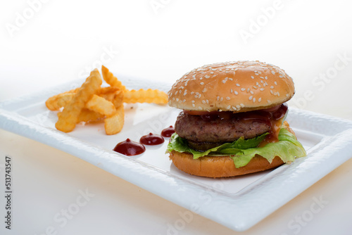 Big Hamburger with fries and ketchup on white bagkground