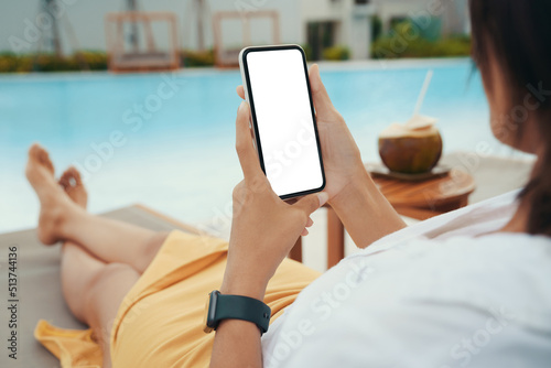 woman holding a white screen phone relaxing on the pool