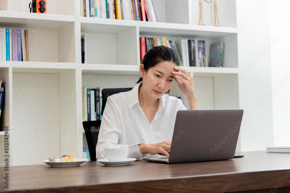 sad depression serious people from work,study stress problem.asian woman feeling tired suffering using computer working work place.concept global economic,health problems sad depression serious people from work,study stress problem.asian woman feeling tired suffering using computer working work place.concept global economic,health problems