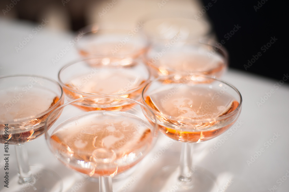 group of glasses with pink champagne on a high-class reception 