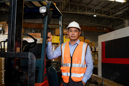 Portrait of male supervisor standing in warehouse with looking at camera.