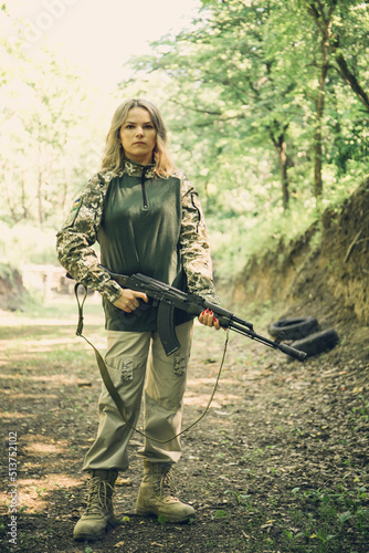 Ukrainian military woman with a machine gun