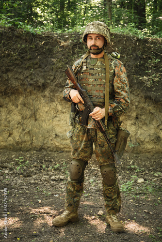 Portrait of a Ukrainian military man with a Kalashnikov assault rifle