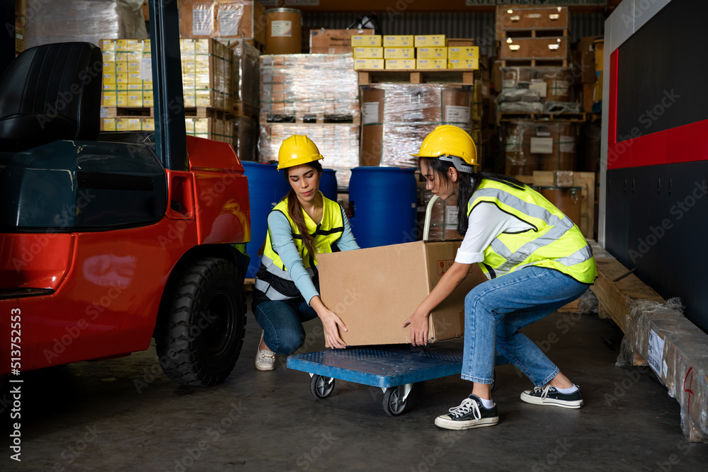 Women warehouse employee worker enjoy working with friend at workplace, teamwork concept. Women warehouse employee worker enjoy working with friend at workplace, teamwork concept.