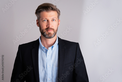 Confident businessman portrait while standing at isolated background