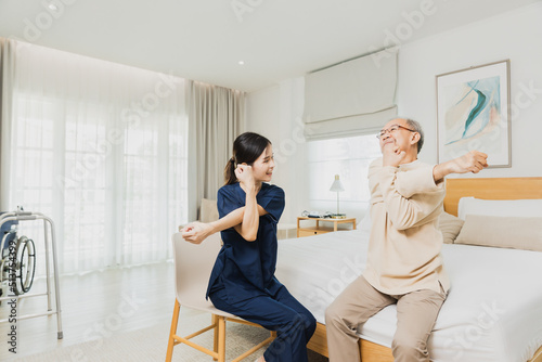 nurse woman assisting old man warming up exercises for the upper body inside the nursing home, use walker with strong health and Help and care concept