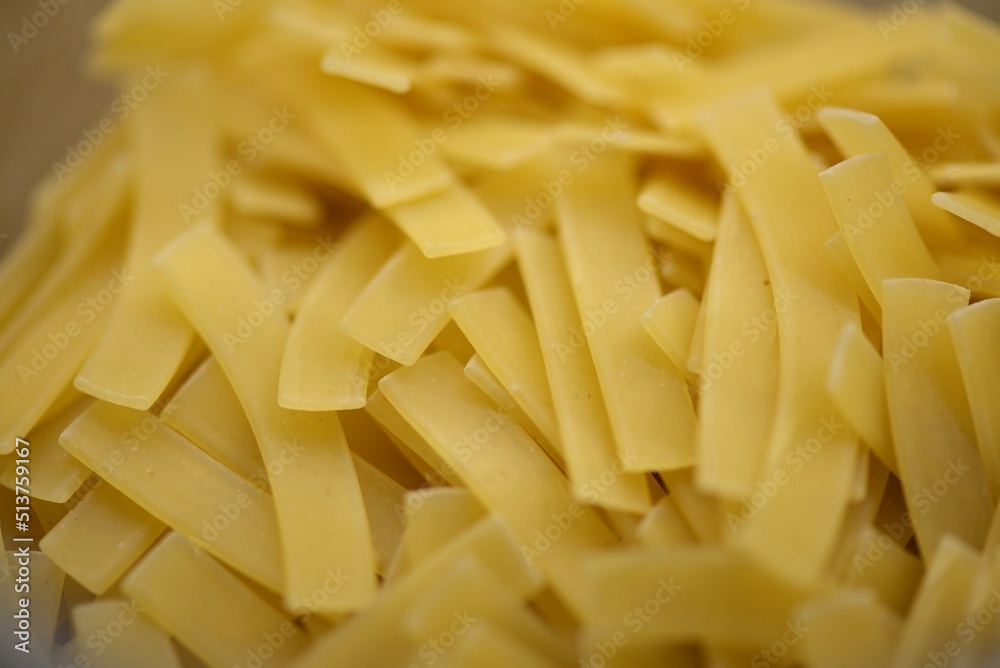 Layout of Italian raw pasta, top view, durum wheat noodles, close-up, macro photo Layout of Italian raw pasta, top view, durum wheat noodles, close-up, macro photo