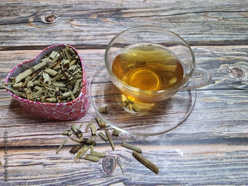 A cup of horsetail tea with dried equisetum plant. Organic herb used in alternative medicine. photo