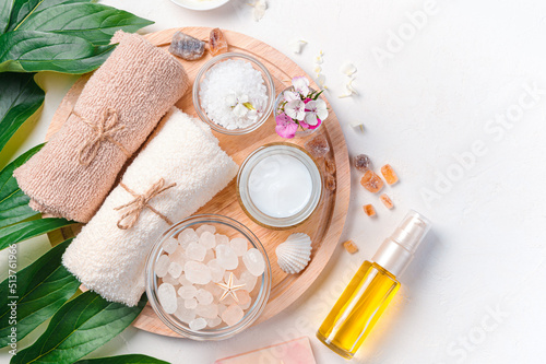 Spa salon with women's cosmetics on a white background top view. Copy space