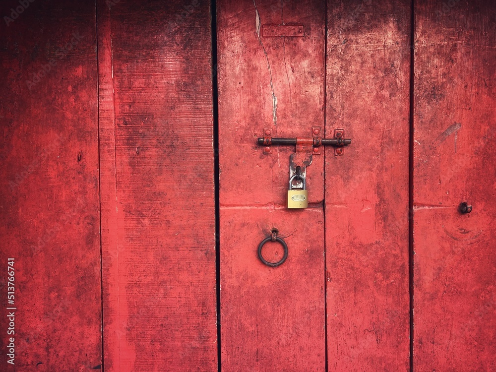 Red colour wooden folding doors with a latch and lock Stock Photo