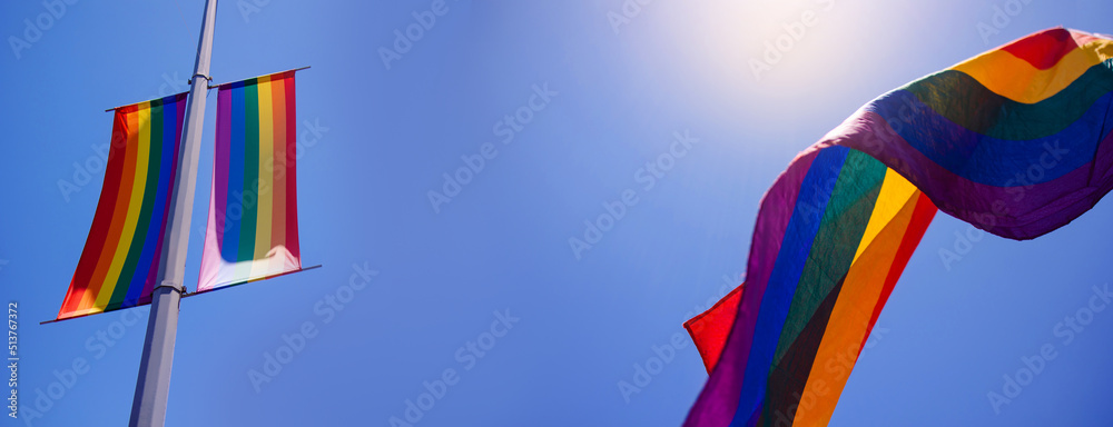 Banner with waving lgbt+ flag. Copy space for text. Summer holiday is the month of pride. Symbol of freedom of tolerance and equal rights of homosexuals. Six colors rainbow against the sky. June Banner with waving lgbt+ flag. Copy space for text. Summer holiday is the month of pride. Symbol of freedom of tolerance and equal rights of homosexuals. Six colors rainbow against the sky. June
