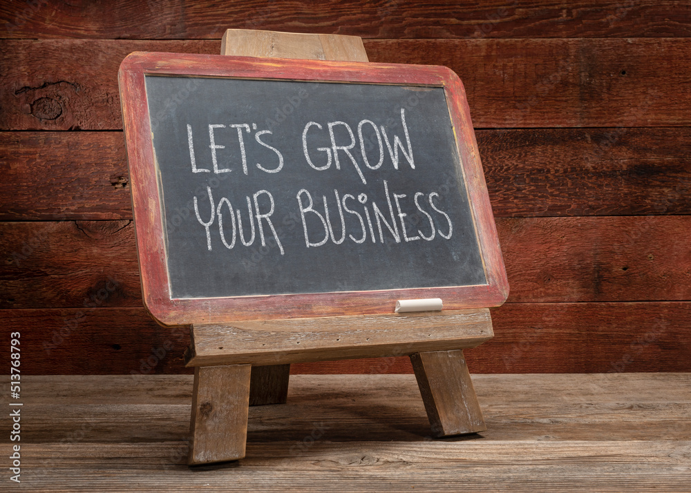 let's grow your business blackboard easel sign on rustic wood, offer, help or service concept
