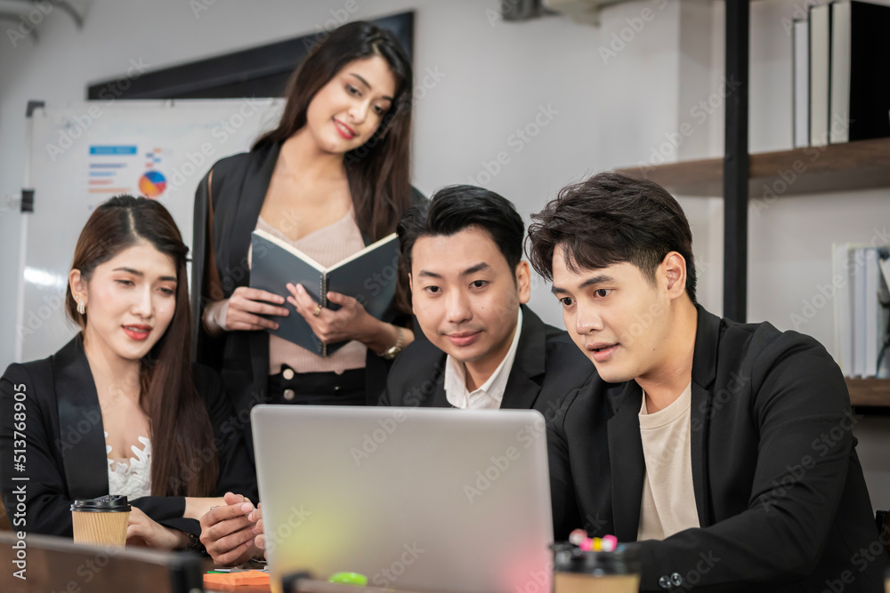 A group of young Asian businessmen Talking and planning work happily and have fun. at the company's office A group of young Asian businessmen Talking and planning work happily and have fun. at the company's office