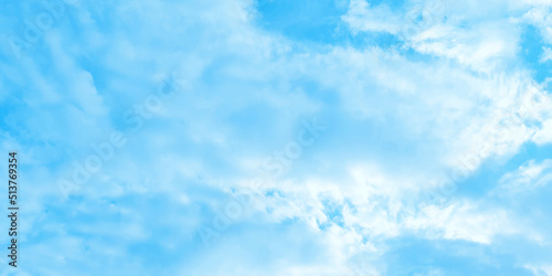 Cloudy and bright shinny blue sky background with white clouds, fluffy and blurry summer sky background for wallpaper and design related works.