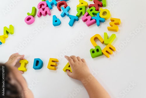 hands holding colorful letters