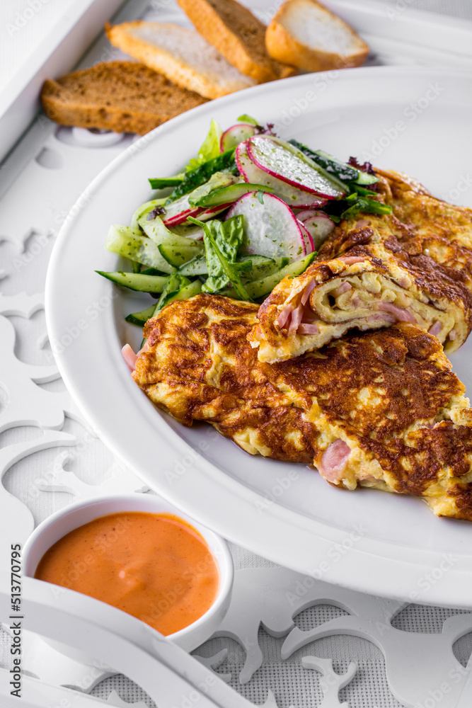 Fried omelet with slices of ham Fried omelet with slices of ham