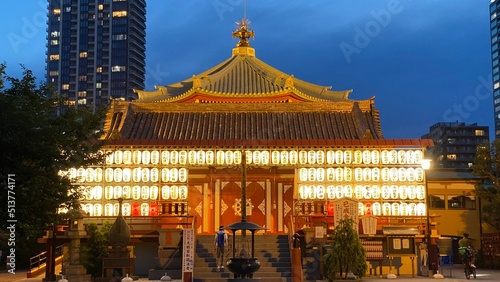 Beautiful scenery of night temple at Tokyo downtown, Ueno “Bentendo” temple on the island of a pond, vivid beautiful sky contrast and the golden paper lantern lights. Year 2022 June 25th