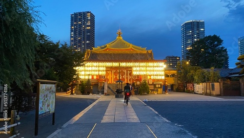 Beautiful scenery of night temple at Tokyo downtown, Ueno “Bentendo” temple on the island of a pond, vivid beautiful sky contrast and the golden paper lantern lights.  Year 2022 June 25th photo