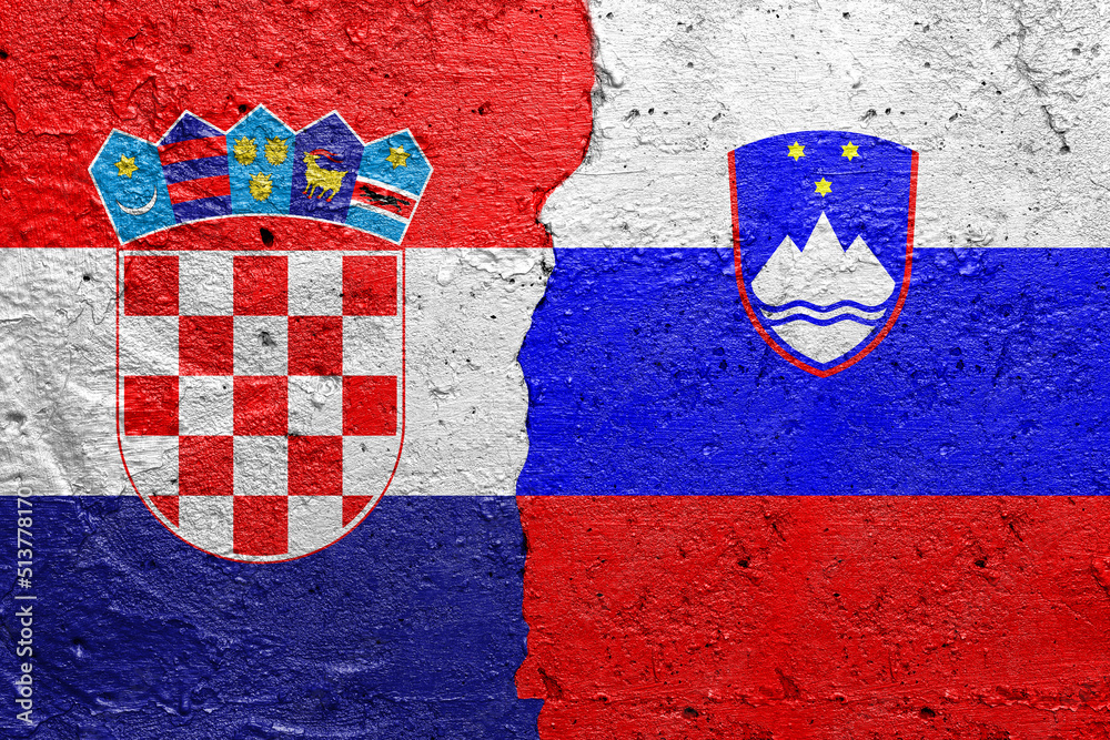 Croatia and Slovenia - Cracked concrete wall painted with a Croatian flag on the left and a Slovenian flag on the right stock photo