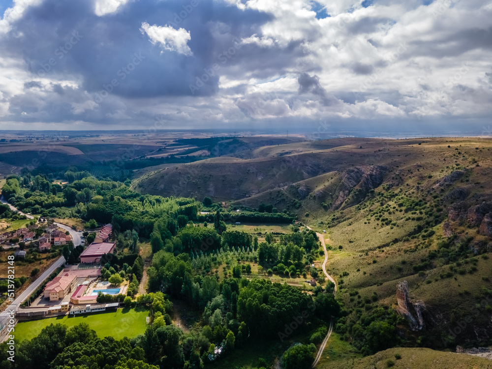 Fototapeta premium Aerial view of the valley formed by hills and buildings at the bottom of the ravine, Spain.