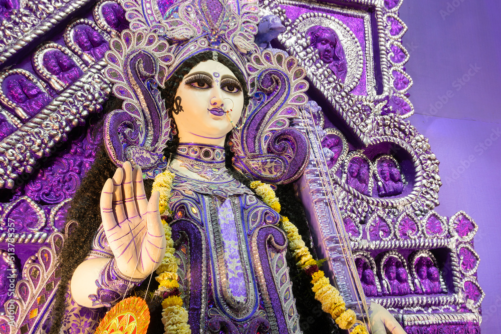 Fototapeta premium Blessing hand , Idol of Goddess Saraswati at Kolkata, West Bengal, India. Saraswati is Hindu goddess of knowledge, music, art, wisdom, and learning. Worshipping is done in spring in India.