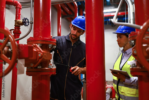 System engineer and Maintenance check fire suppression system, Fire Pump control room with red piping and valves