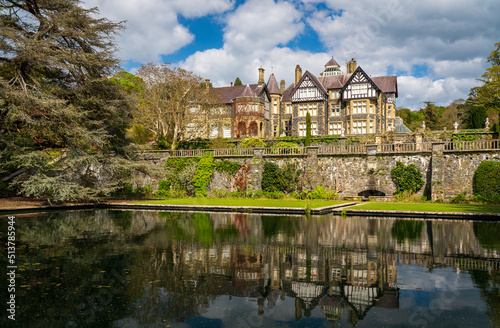 Reflection in the pond and gardens of the old manor home at Bodnant Garden in North Wales in the spring