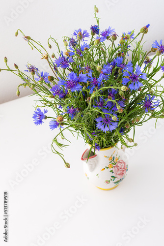 Beautiful summer Centaurea triumfettii flowers in a vase, part of home interior