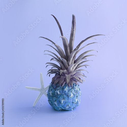 abstract photo of blue pineapple over purple background. Holidays, beach and tropical theme