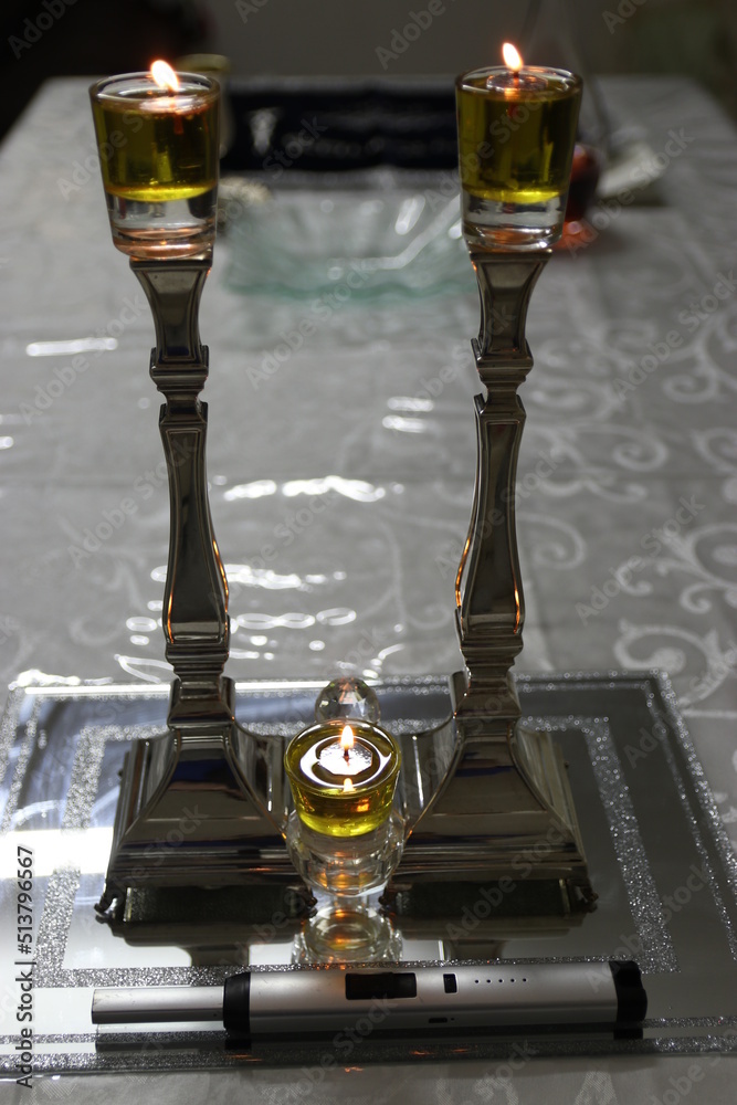Shabbat candles are lit with oil in silver candlesticks. Orthodox Jewish custom on Saturday
